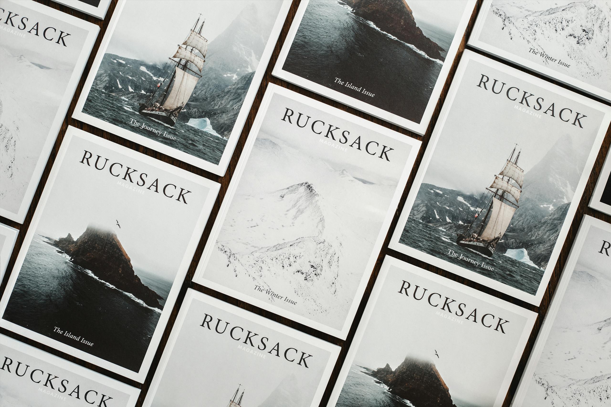 A flat lay of Rucksack magazine issues with nautical exploration themes, featuring ships and snowy landscapes.